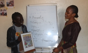 Jeunes filles leaders de N'zérékoré, procédant à une démonstration de sensibilisation avec la boîte à images